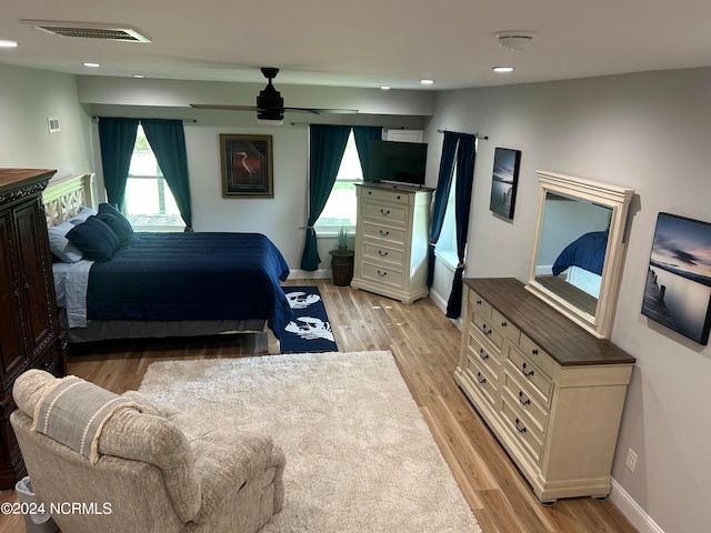 bedroom with ceiling fan and light hardwood / wood-style floors