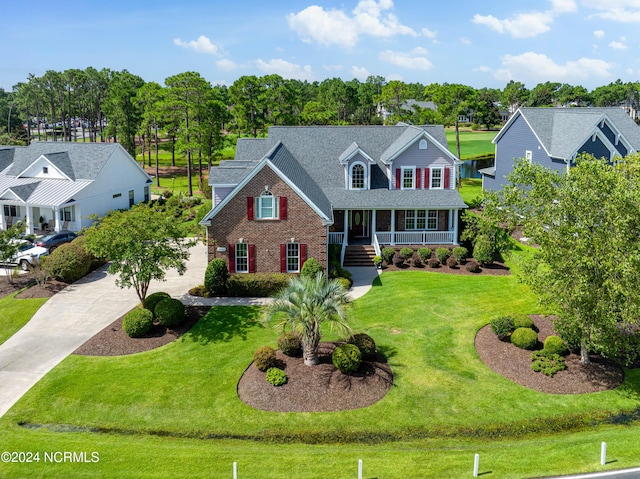 view of front of property with covered porch and a front yard