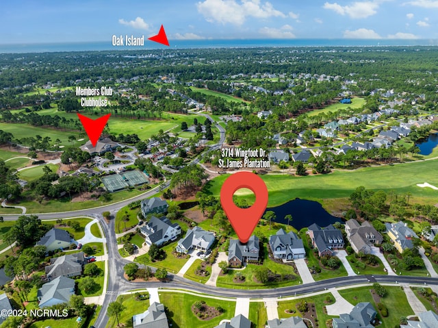 drone / aerial view featuring view of golf course, a water view, and a residential view