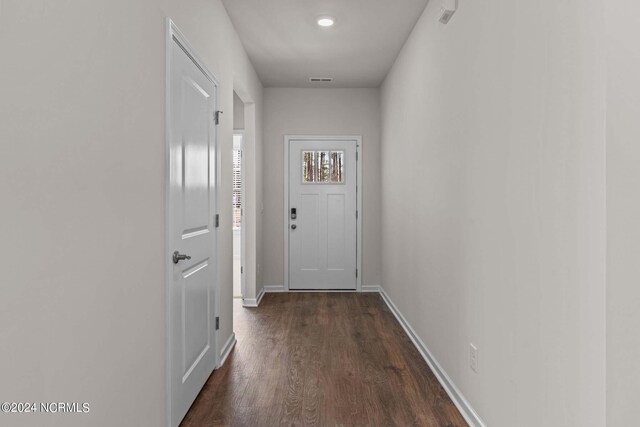 entryway with dark hardwood / wood-style flooring