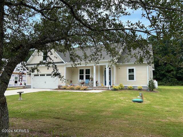 view of front facade with a porch, a garage, and a front lawn