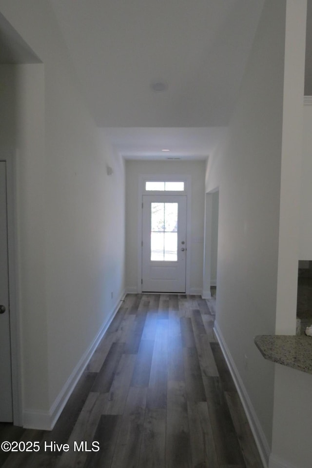 hallway with dark hardwood / wood-style flooring