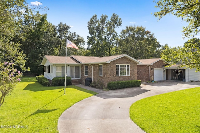 ranch-style house featuring a garage, concrete driveway, a front lawn, and brick siding