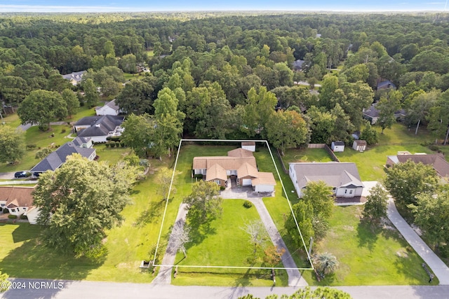 drone / aerial view featuring a residential view and a view of trees