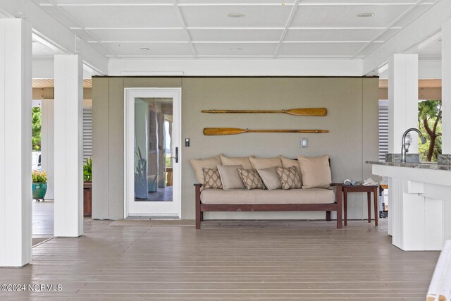 interior space with sink, hardwood / wood-style flooring, and coffered ceiling