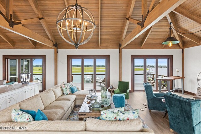 living room with beam ceiling, light hardwood / wood-style floors, plenty of natural light, and wooden ceiling