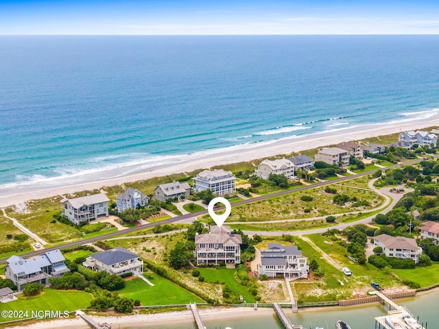 drone / aerial view featuring a water view and a view of the beach