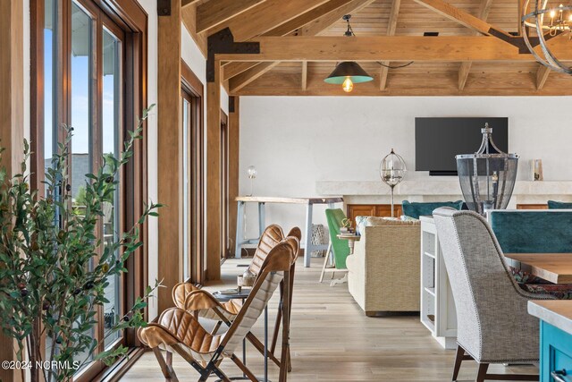 interior space featuring wood ceiling, light wood-type flooring, an inviting chandelier, and vaulted ceiling with beams