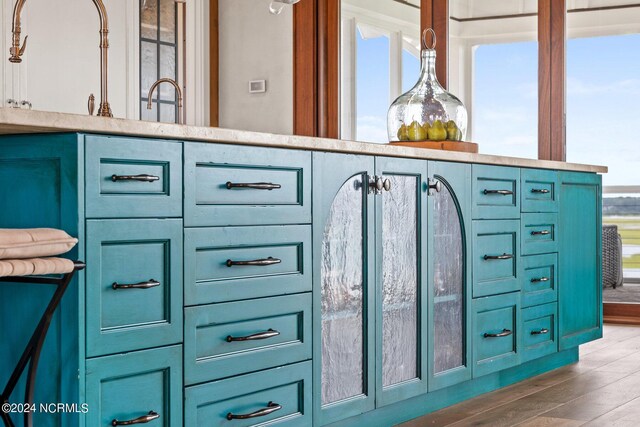 interior space with dark hardwood / wood-style flooring, blue cabinetry, and a healthy amount of sunlight