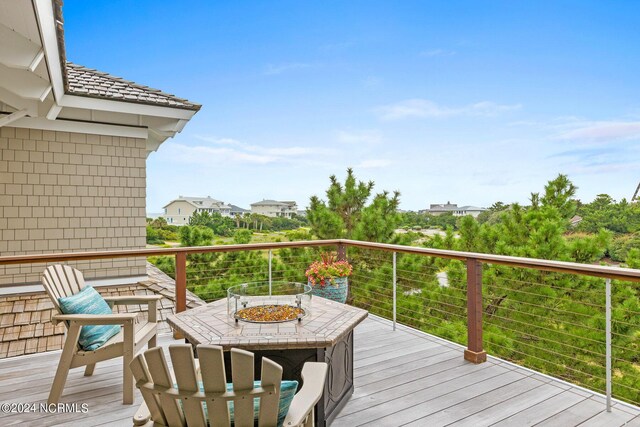 wooden terrace with a fire pit