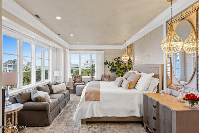 carpeted bedroom featuring a notable chandelier and multiple windows