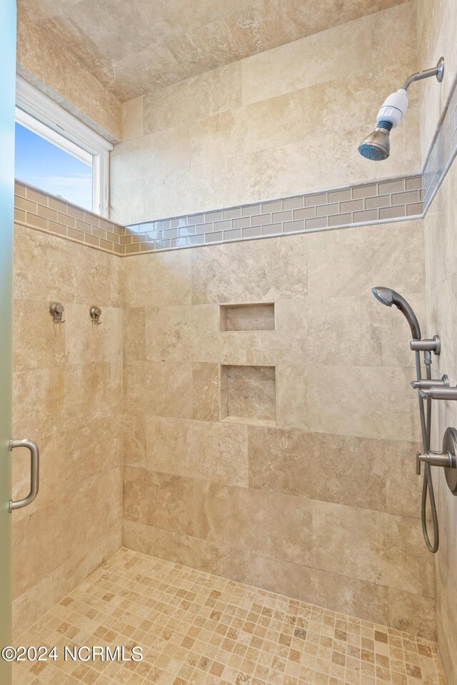 bathroom with a shower with shower door