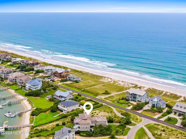 bird's eye view featuring a water view and a beach view