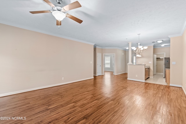 unfurnished living room with light tile patterned flooring, ceiling fan with notable chandelier, and ornamental molding