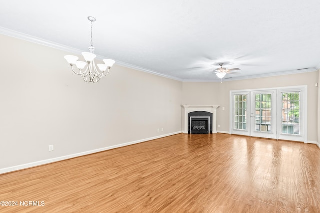 unfurnished living room featuring crown molding, light wood-type flooring, and ceiling fan with notable chandelier