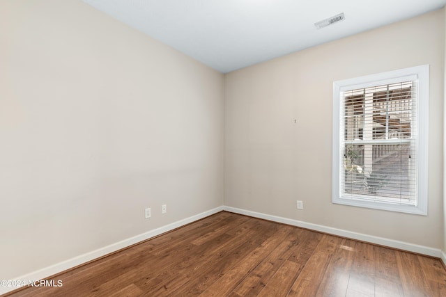 empty room featuring wood-type flooring and a wealth of natural light