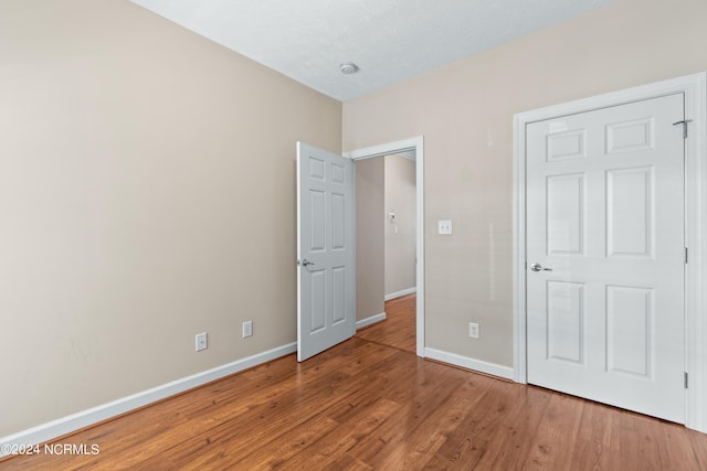 unfurnished bedroom with hardwood / wood-style flooring