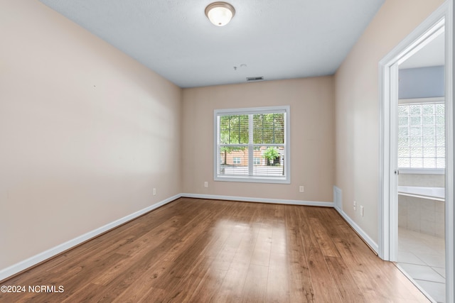 empty room with hardwood / wood-style flooring