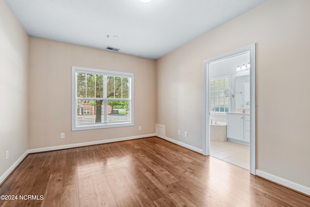 unfurnished room with a wealth of natural light and light wood-type flooring