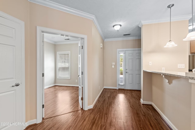 entrance foyer with crown molding, dark hardwood / wood-style floors, and a textured ceiling