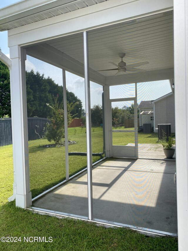 unfurnished sunroom with ceiling fan and a healthy amount of sunlight