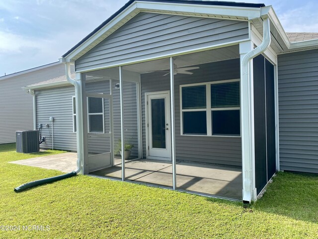 back of house featuring a yard, ceiling fan, a sunroom, a patio area, and central AC