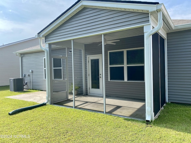 rear view of property featuring cooling unit, a yard, a sunroom, and a patio area