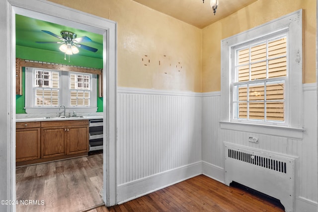 interior space featuring sink, radiator, hardwood / wood-style floors, and ceiling fan