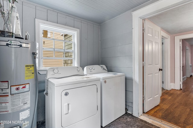 laundry area featuring washer and dryer, crown molding, gas water heater, and dark hardwood / wood-style flooring