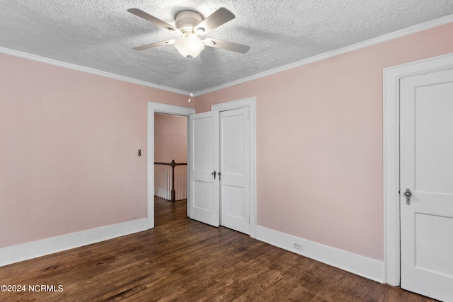 unfurnished bedroom with ceiling fan, ornamental molding, dark wood-type flooring, and a textured ceiling