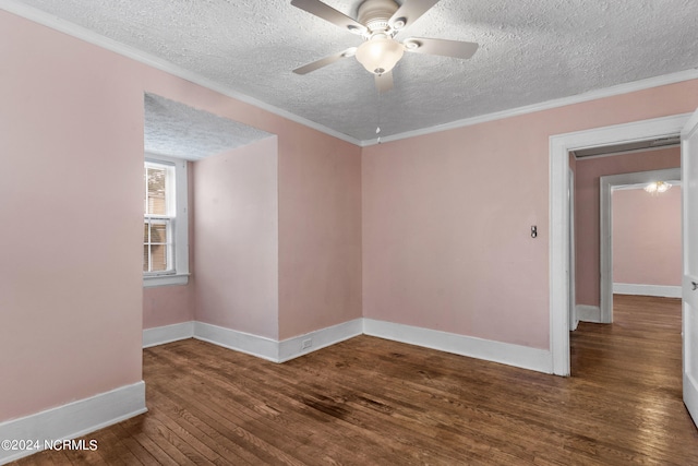 empty room with a textured ceiling, ornamental molding, dark hardwood / wood-style floors, and ceiling fan