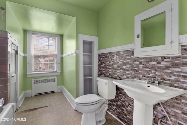 bathroom featuring radiator heating unit, tile patterned flooring, and toilet