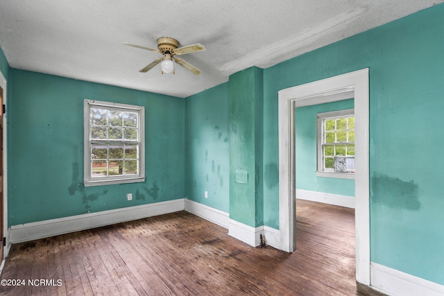 spare room featuring ceiling fan, a textured ceiling, and dark hardwood / wood-style flooring