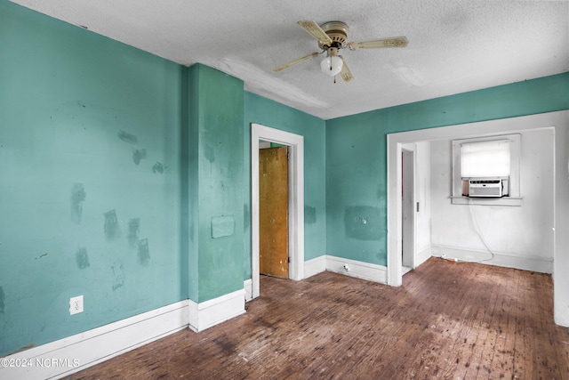 spare room with cooling unit, ceiling fan, dark hardwood / wood-style flooring, and a textured ceiling