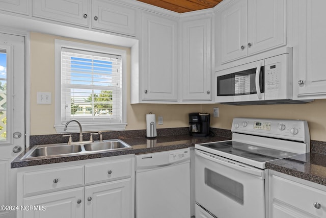 kitchen with white cabinets, white appliances, and sink