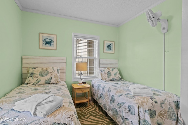 bedroom featuring a textured ceiling and ornamental molding