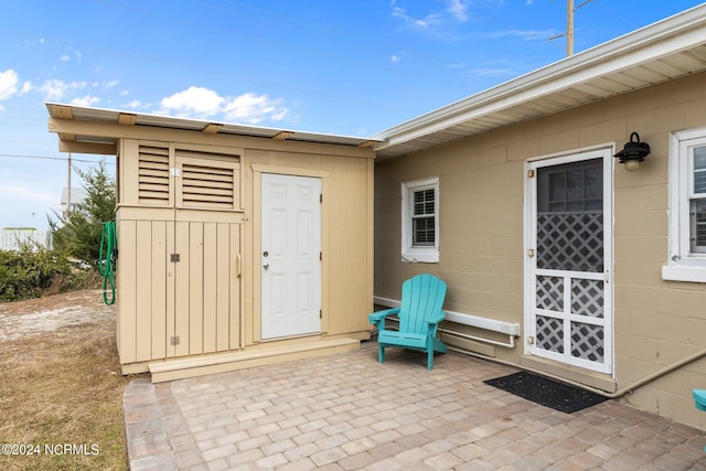 view of patio / terrace with a shed