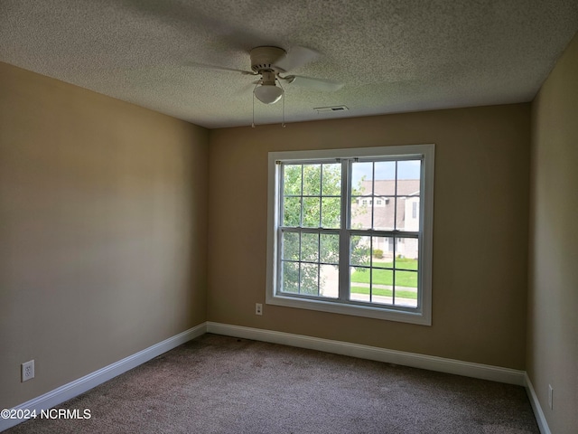 carpeted empty room featuring a textured ceiling and ceiling fan