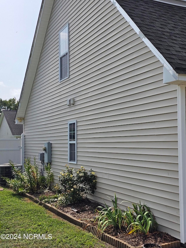 view of side of home with central AC