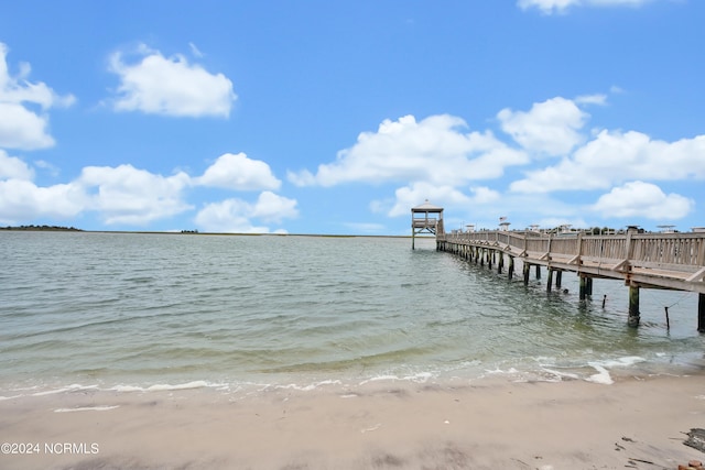 dock area featuring a water view and a view of the beach