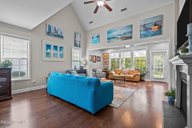 living room featuring ceiling fan, dark wood-type flooring, and high vaulted ceiling