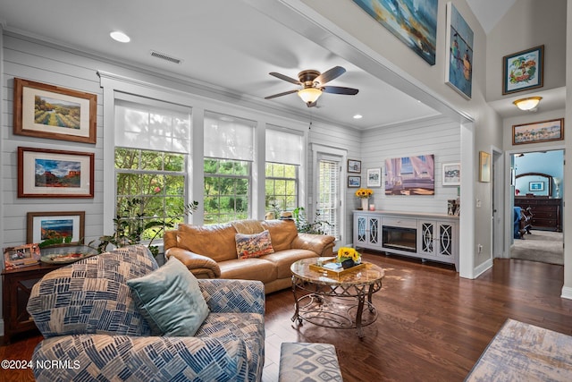 living room with a fireplace, ceiling fan, dark hardwood / wood-style flooring, and crown molding