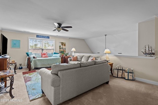 carpeted living room with ceiling fan and vaulted ceiling