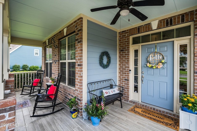 doorway to property featuring ceiling fan and a porch