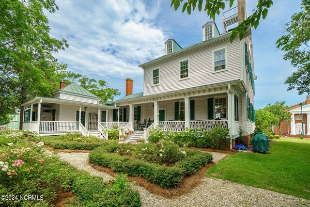 613 Broad St, New Bern, NC 28560 - view of front of home featuring a porch, a front lawn, and a chimney