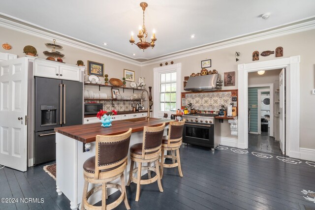 kitchen featuring dark hardwood / wood-style flooring, butcher block countertops, high quality appliances, and a kitchen island