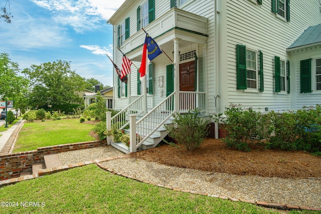 property entrance with a lawn