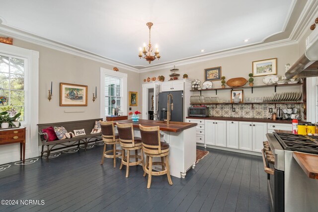 kitchen featuring stainless steel appliances, wood counters, and plenty of natural light