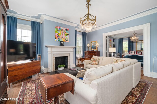 living room featuring wood-type flooring, a notable chandelier, and a wealth of natural light