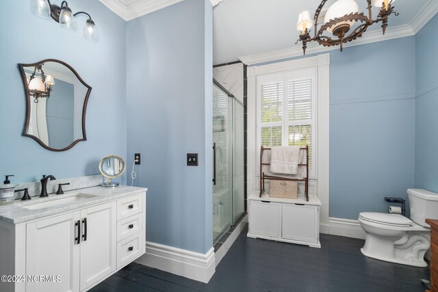 bathroom featuring wood-type flooring, toilet, vanity, and ornamental molding